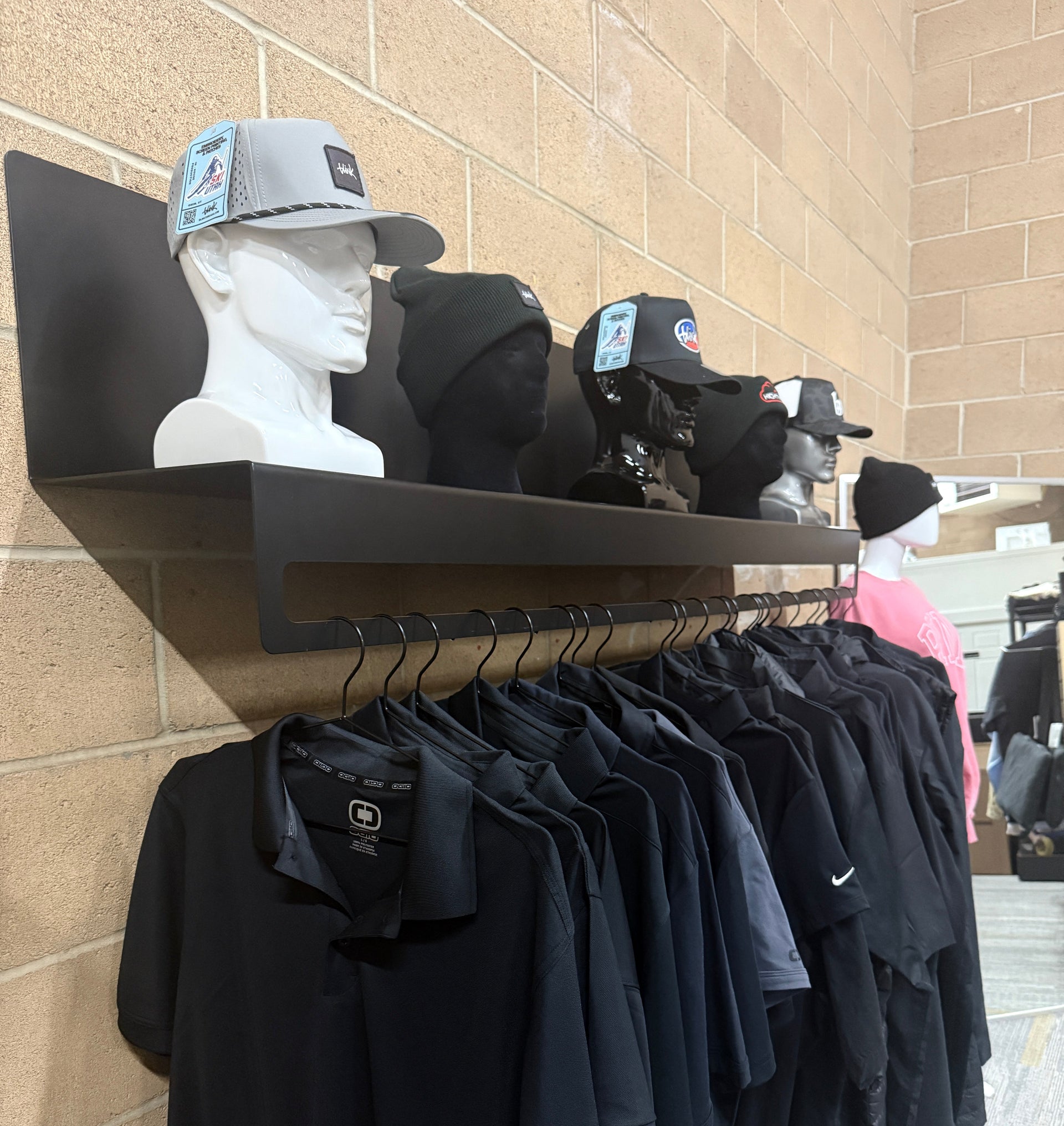 Blink Threads showroom display wall with branded apparel